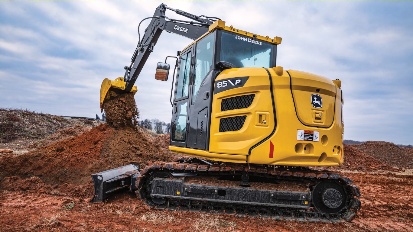 John Deere 85P-Tier Excavator dumping dirt on a worksite.